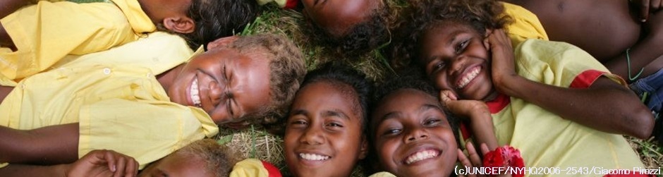 Children smile, laying in a circle at the UNICEF-supported Lunga Primary School in the village of Lunga, outside Honaira, the capital, on Guadalcanal Island.